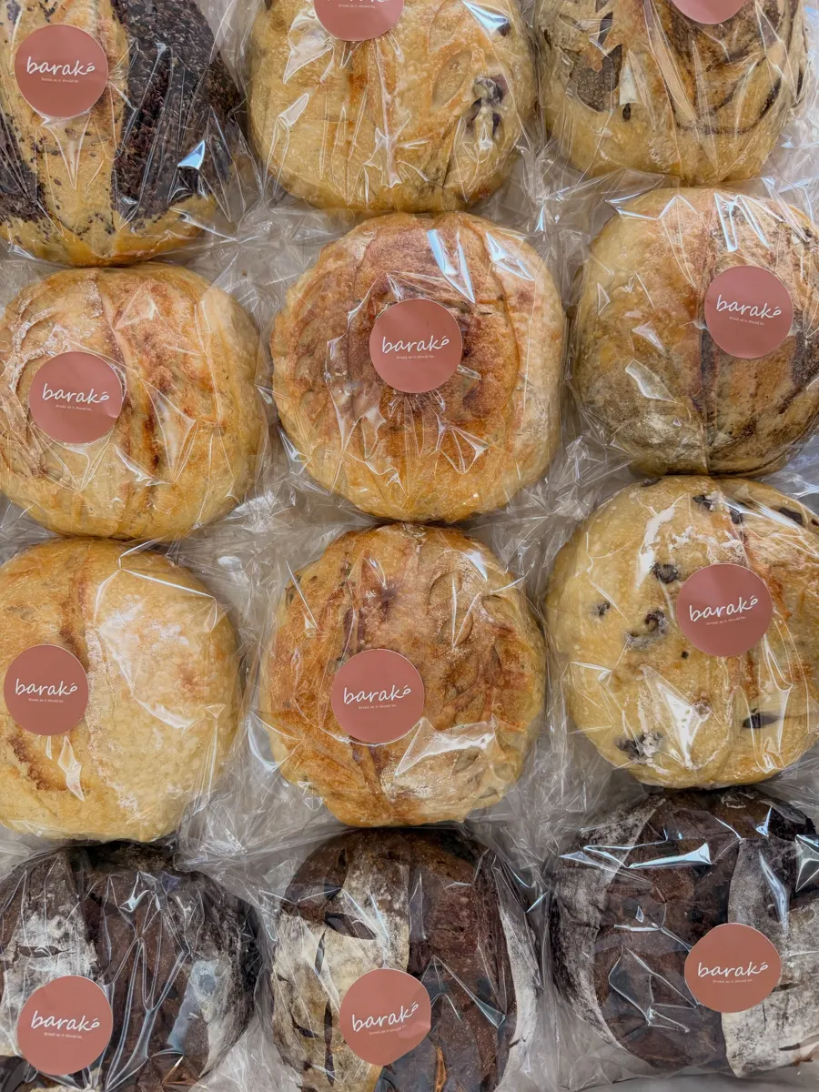 A batch of wrapped Baraké loaves with the Baraké sticker