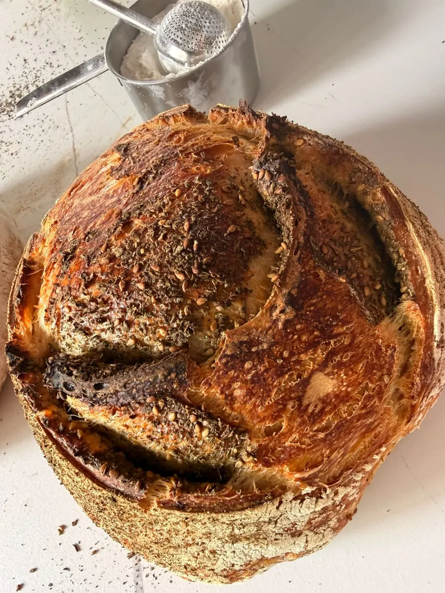 A Baraké sourdough loaf with a dark, crackling crust